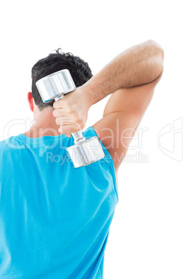 Rear view of a young man exercising with dumbbell