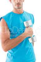 Mid section of a serious man exercising with dumbbell