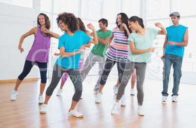 Fitness class and instructor doing pilates exercise