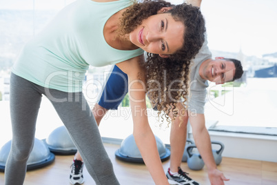 Woman with man doing stretching exercise