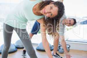 Woman with man doing stretching exercise