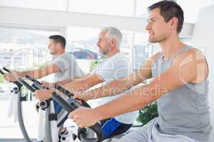 Men working out on exercise machines