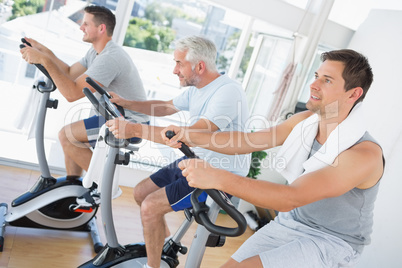 Men exercising on fitness bikes