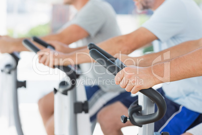 Men using exercise bikes