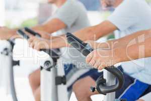 Men using exercise bikes