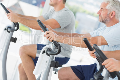 Men using exercise bikes