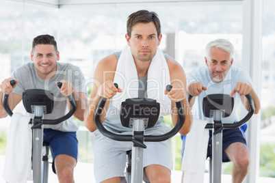 Man with friends on exercise bikes