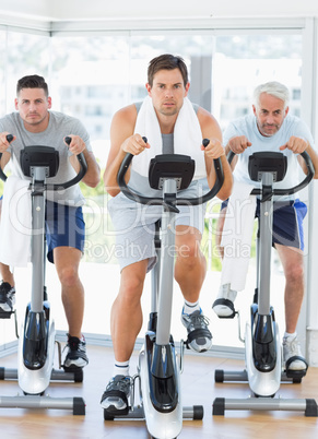 Men using exercise bikes