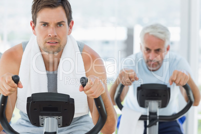 Handsome man using exercise bike