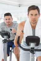 Determined man using exercise bike