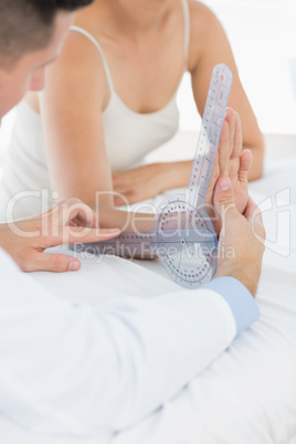 Doctor examining patients wrist