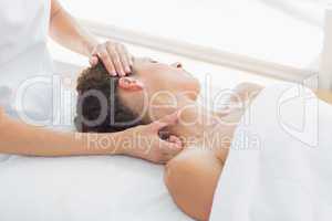 Woman receiving neck massage in spa