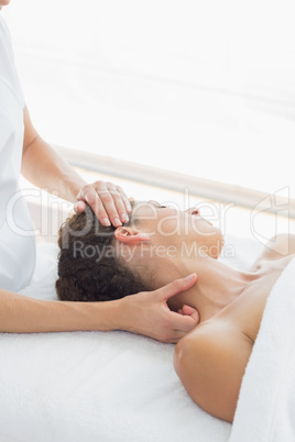 Relaxed woman receiving neck massage