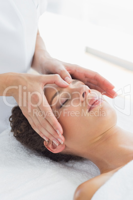 Woman receiving massage on forehead