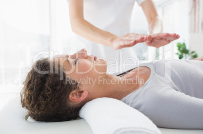 Woman having reiki treatment