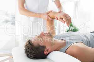Man receiving hand massage from therapist