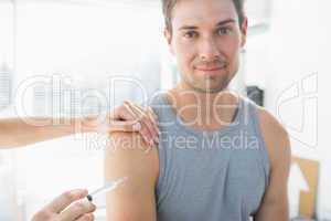 Man being injected by doctor