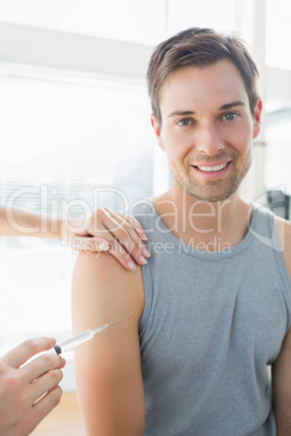 Happy man being injected by doctor