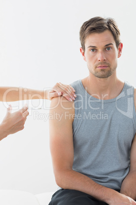 Man receiving injection on arm