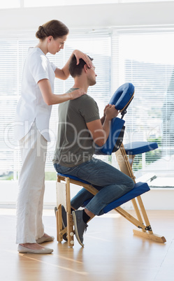 Therapist massaging man in hospital