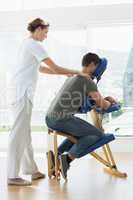 Man receiving shoulder massage from therapist
