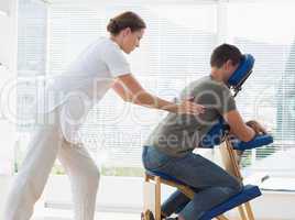 Man receiving back massage from physiotherapist