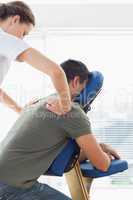 Man receiving back massage from therapist