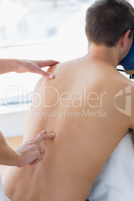 Man receiving back massage by therapist