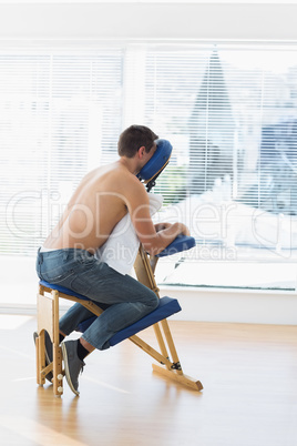 Patient sitting on massage chair