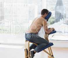 Patient sitting on massage chair in hospital