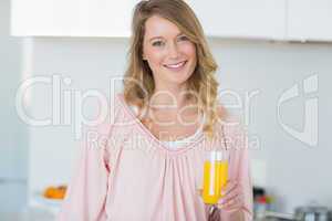 Woman with orange juice in kitchen