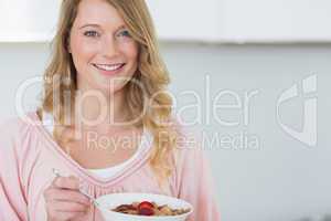 Woman having cereals in kitchen