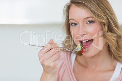 Woman eating salad with fork