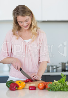 Woman chopping vegetables at kitchen counter