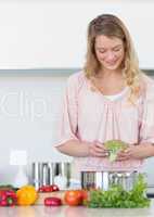 Woman preparing broccoli in kitchen