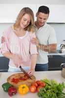 Couple preparing food at kitchen counter