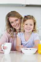 Mother and daughter having breakfast at home