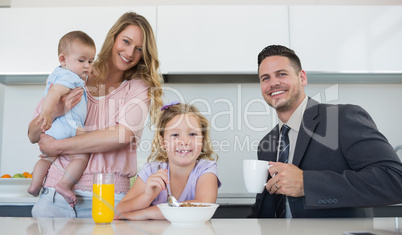 Happy family at table in house