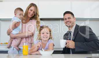 Happy family at table in house