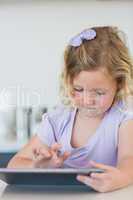 Girl using tablet computer at table