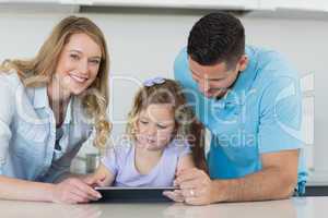 Family using digital tablet at table