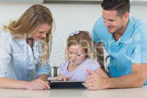 Family using tablet PC at table