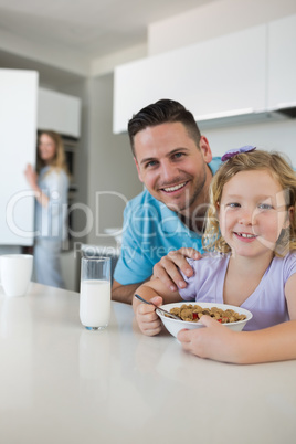 Father and daughter at breakfast table