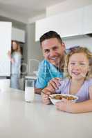 Father and daughter at breakfast table