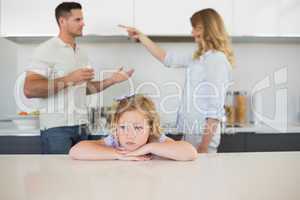 Sad girl against arguing parents