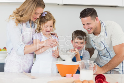 Family of four preparing cookies