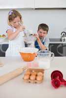 Children baking cookies in kitchen