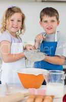 Children baking cookies together in kitchen