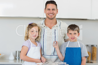 Family in aprons baking cookies