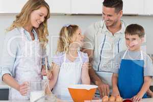 Family baking cookies together in kitchen